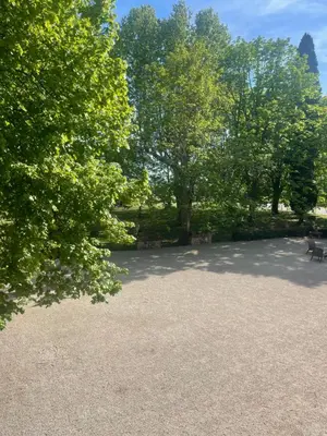 a park with a bench and trees in the background at Suite le Quervalat dans magnifique bastide 18eme in Aix-en-Provence