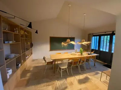 a dining room with a wooden table and chairs at Villa des Mattes - Superbe maison de famille 15 couchages in Crillon-le-Brave