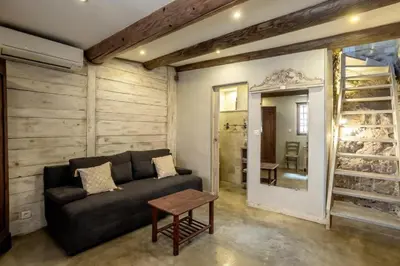 a living room with a couch and a table at La maison du château in Fontaine-de-Vaucluse