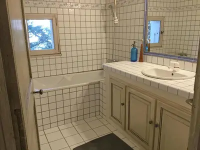 a white tiled bathroom with a sink and a mirror at Provencal farmhouse, pool, pool house, countryside Plan d’Orgon, Provence - 8 people in Plan-dʼOrgon