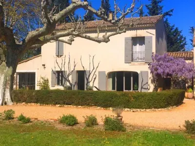 a white house with a tree and purple flowers at Provencal farmhouse, pool, pool house, countryside Plan d’Orgon, Provence - 8 people in Plan-dʼOrgon
