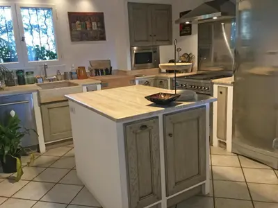 a kitchen with an island in the middle of it at Provencal farmhouse, pool, pool house, countryside Plan d’Orgon, Provence - 8 people in Plan-dʼOrgon