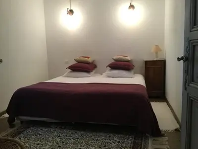 a bedroom with a bed with three pillows on it at Provencal farmhouse, pool, pool house, countryside Plan d’Orgon, Provence - 8 people in Plan-dʼOrgon
