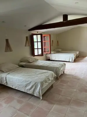 a bedroom with three beds in a room at La Planette in Venasque
