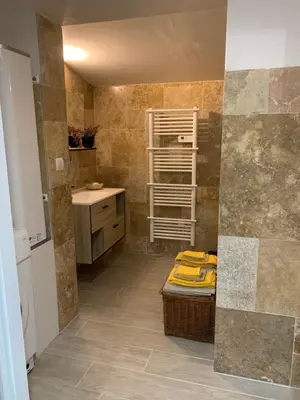 a bathroom with a sink and a counter with a shelf at Standing duplex FULL Equipements idéal moyen séjours in Le Thor