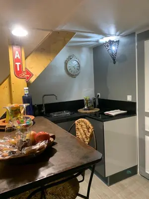 a kitchen with a table with a bowl of food on it at Standing duplex FULL Equipements idéal moyen séjours in Le Thor