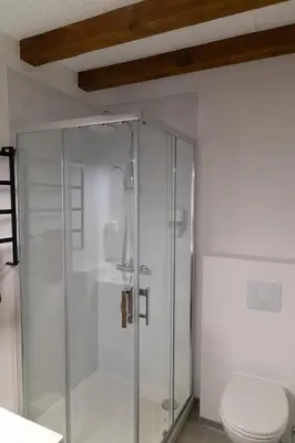 a glass shower in a bathroom with a toilet at La Halte Gourmande in Vachères