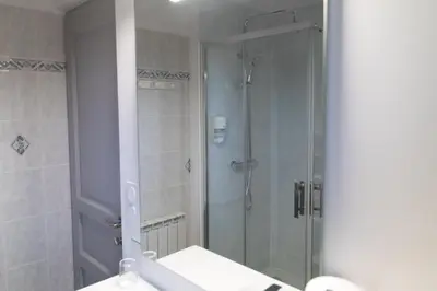 a shower with a glass door in a bathroom at La Halte Gourmande in Vachères