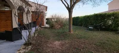 a yard with a tree next to a house at La Halte Gourmande in Vachères