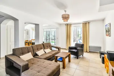 a living room with a couch and a chair at Les Mas et Villas de Pont Royal en Provence - maeva Home - Villa 5 Pièces 8 Personnes avec piscine privée et vue sur le golf - Exclusive - super Home MAE-6074 in Mallemort