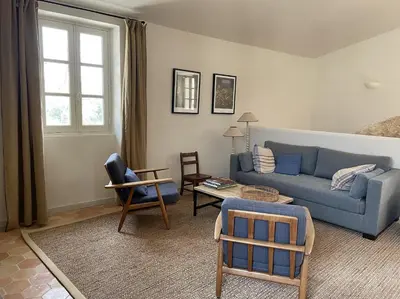 a living room with a blue couch and chairs at VENTOUX in Apt