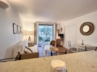 a living room with a couch and a table at Escale détente - Résidence 4* au sein d'un Golf in Saumane-de-Vaucluse