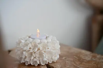 a white cake with a candle on top of it at Lovina chambre de charme avec jacuzzi in Velaux