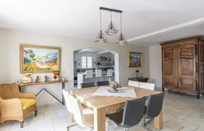 a kitchen and dining room with a table and chairs at La marinette in Fontaine-de-Vaucluse