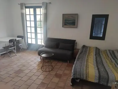 a living room with a couch and a table at Studio en pleine campagne in Le Thor