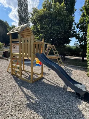 a wooden playground with a slide and a play structure at Chambre d'hôtes Zephyr Libeccio Le Moulin de Prédelles in Reillanne