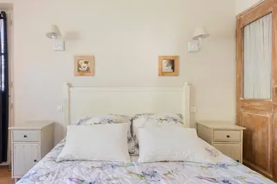 a bedroom with a bed with two pillows at Mas de Lure in Salon-de-Provence