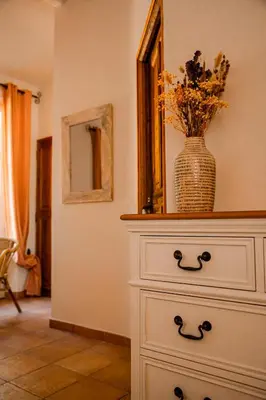 a white dresser with a vase on top of it at Mas de Lure in Salon-de-Provence