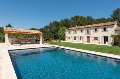 a large swimming pool in front of a house at Mas de Lure in Salon-de-Provence