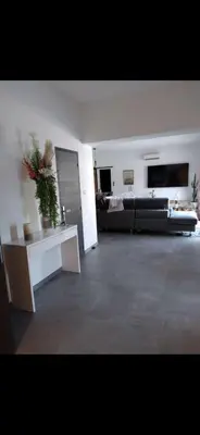 a large living room with a couch and a table at Villa contemporaine in Pernes-les-Fontaines