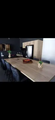 a long table with chairs and a television in a room at Villa contemporaine in Pernes-les-Fontaines