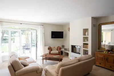 a living room with two couches and a tv at Maison Cocoon Lourmarin 6 personnes in Lourmarin