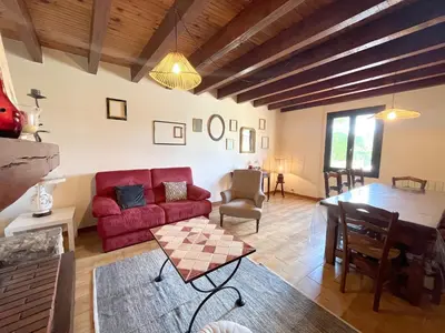 a living room with a red couch and a table at Maison avec piscine - Luberon in Saint-Saturnin-les-Apt