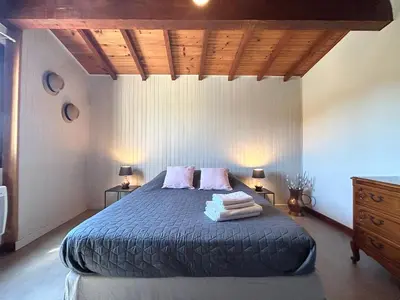 a bedroom with a bed with two lamps and a dresser at Maison avec piscine - Luberon in Saint-Saturnin-les-Apt