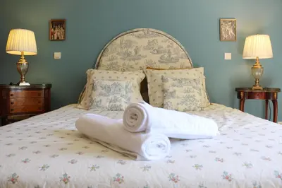 a bed with two towels on it with two lamps at Les Chambres de Fanny in Cabrières-dʼAigues