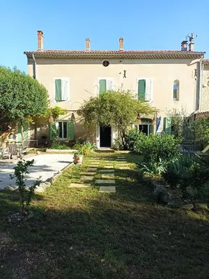 a large house with a garden in front of it at Maison Rosiris in Pernes-les-Fontaines