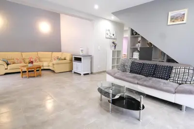 a living room with a couch and a table at very pleasant villa with private swimming pool, in a residential area near the center of saint-rémy-de-provence - 8 people in Saint-Rémy-de-Provence