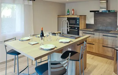 a kitchen with a large wooden table and chairs at Stunning Apartment In Villes Sur Auzon in Villes-sur-Auzon