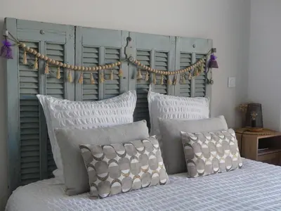 a bedroom with a bed with pillows and a headboard at Studio Nuitée en Provence 2 in Aix-en-Provence