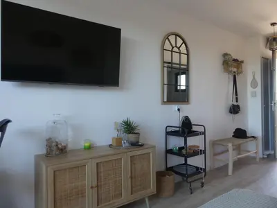 a living room with a flat screen tv on a wall at Studio Nuitée en Provence 2 in Aix-en-Provence