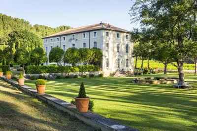 a large white house with plants in front of it at Chateau Talaud in Loriol-du-Comtat