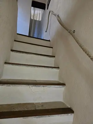 a stairway with a chain leading up to a window at La Mauricette - free Parking & Cancellation - WiFi in Pélissanne