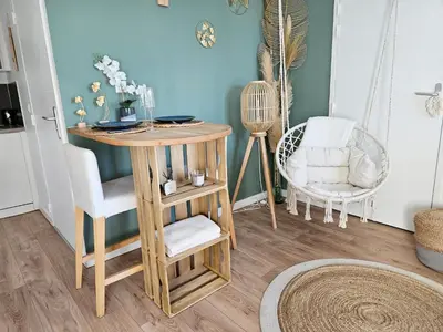 a small table in a room with a chair at 107 Paisible et unique avec terrasse sur vue piscine in Éguilles