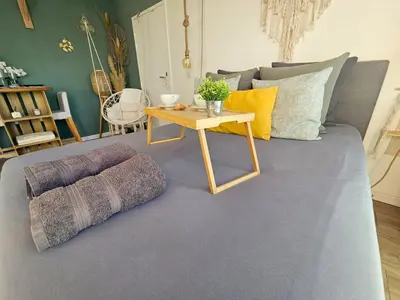 a living room with a couch with a table at 107 Paisible et unique avec terrasse sur vue piscine in Éguilles