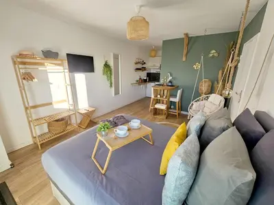 a living room with a blue couch and a table at 107 Paisible et unique avec terrasse sur vue piscine in Éguilles