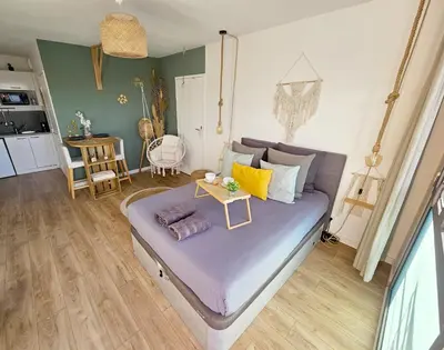 a bedroom with a bed with a table on it at 107 Paisible et unique avec terrasse sur vue piscine in Éguilles