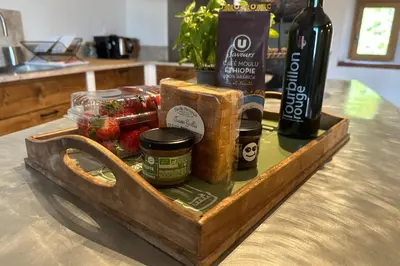 a wooden tray with food and a bottle of wine at Mas Sylvie - Isle-sur-la-Sorgue in LʼIsle-sur-la-Sorgue