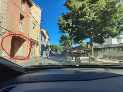 a group of people sitting outside of a building at Appartement de Charme L'Isle-sur-la-Sorgue sur la Sorgues in LʼIsle-sur-la-Sorgue