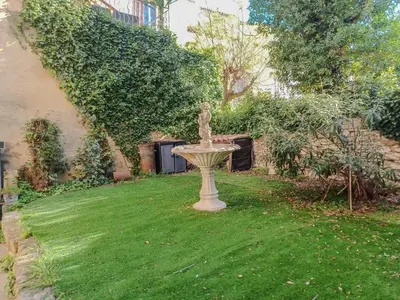 a fountain in the grass in a yard at Appartement spacieux à Aix-en-Provence 100 m² avec hammam in Aix-en-Provence