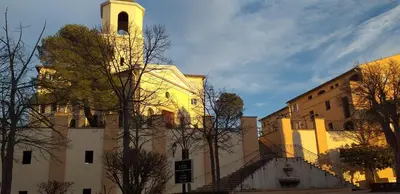 a building with a clock tower on top of it at Appartement vue panoramique au domaine et golf de pont royal in Mallemort