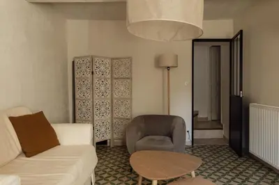 a living room with a couch and a chair and a table at L'Olivier in Mormoiron
