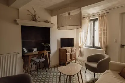 a living room with a couch and a table at L'Olivier in Mormoiron