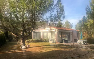 a small house with a tree in the yard at 3 Bedroom Cozy Home In Meyrargues in Meyrargues