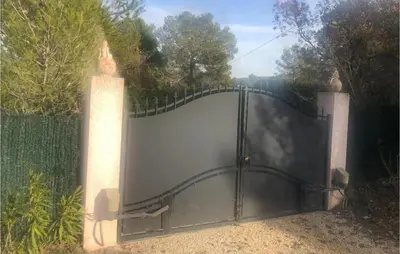 a black fence with a gate in a garden at 3 Bedroom Cozy Home In Meyrargues in Meyrargues