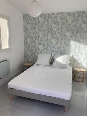 a bedroom with a white bed with two pillows at La Manuia in Ventabren