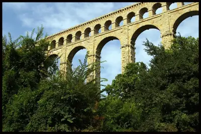a stone bridge with arches on top of trees at La Manuia in Ventabren